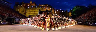 World Famous Edinburgh Tattoo A military parade with performers in uniforms, set against a castle at night.